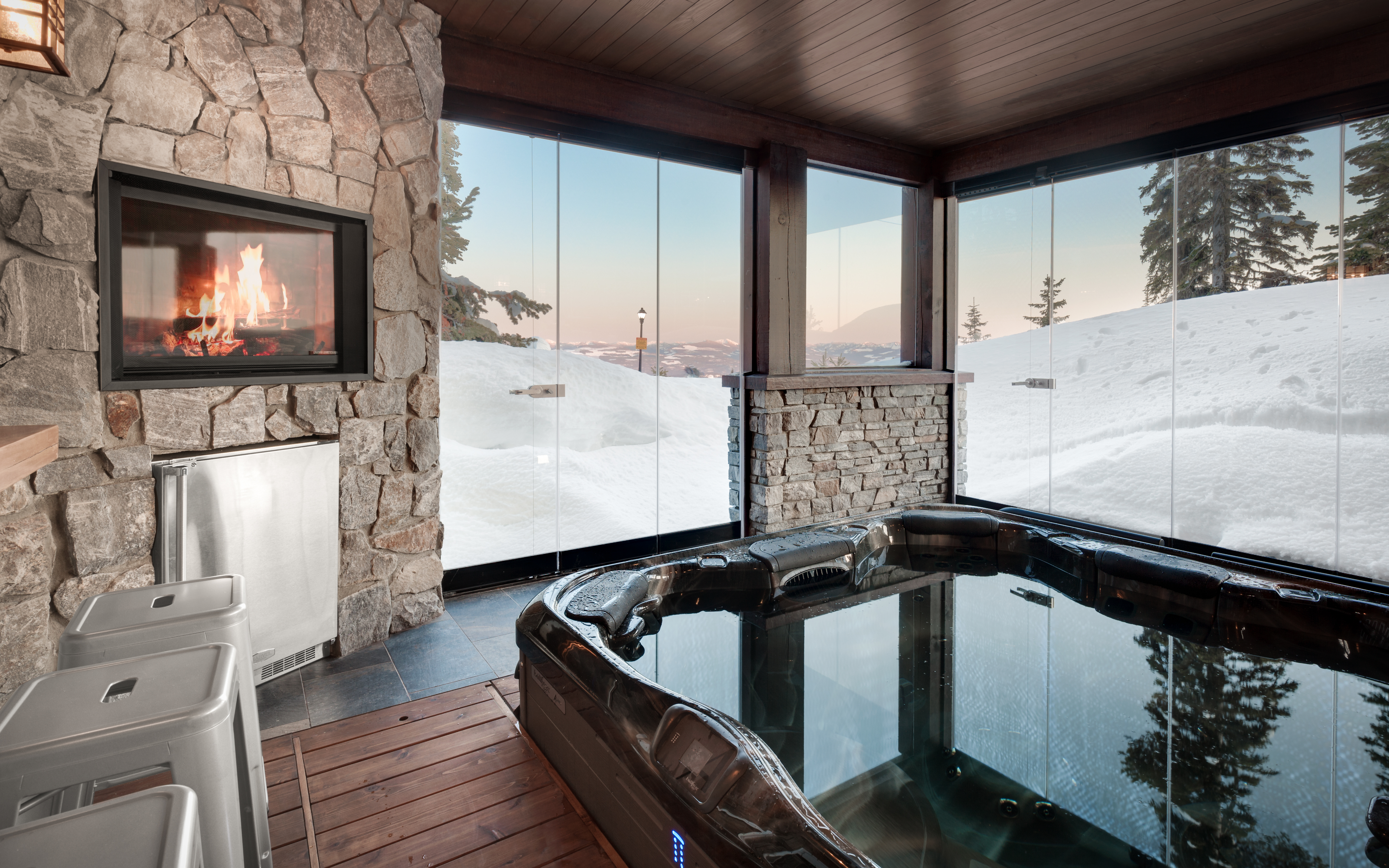 Home hot tub in custom build sunroom - custom ski chalet - outdoor fireplace and lounge with mountain views - vacation home relaxing 
